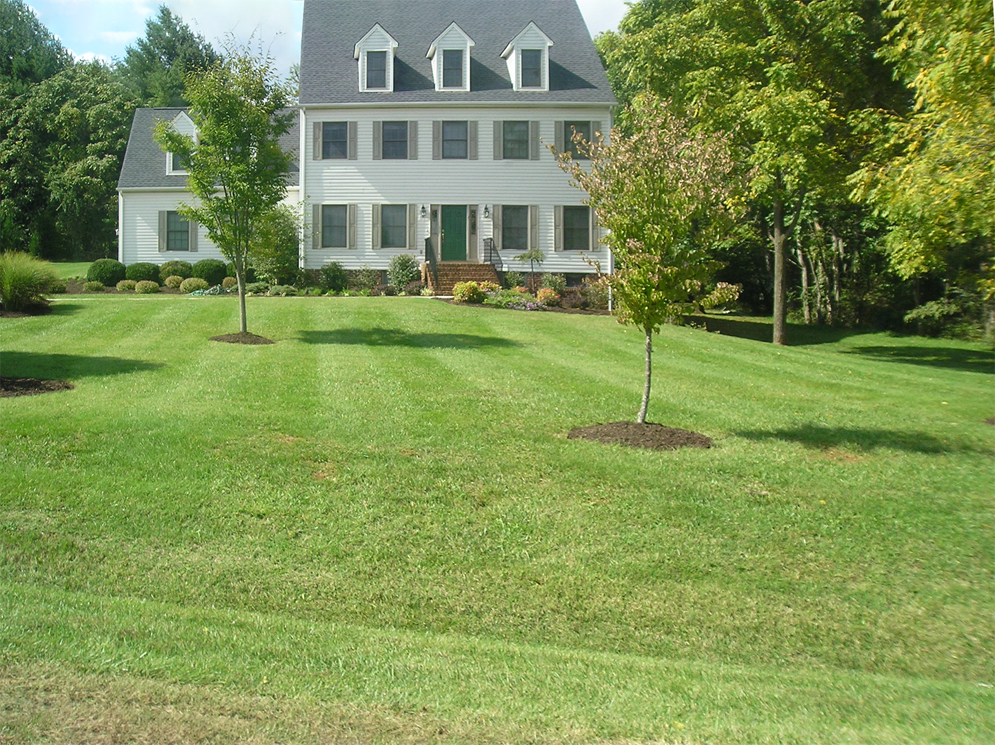 Beautiful home and lawn with lawncare by ADC Lawncare & Bobcat Service